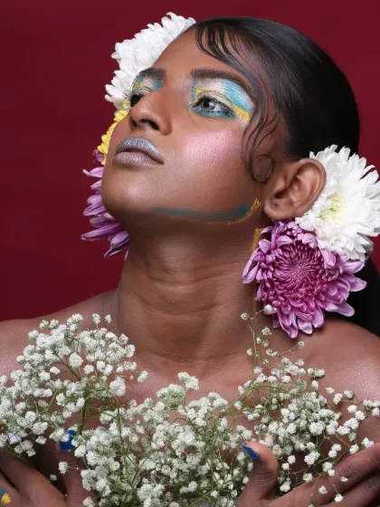 This pose highlights the interplay between the colorful makeup and the floral hair accessories in this nature-inspired editorial.