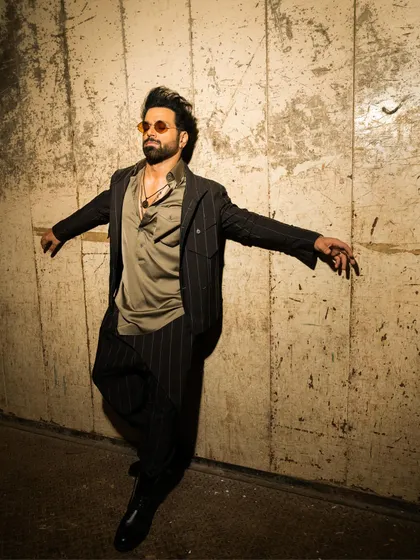 The dynamic movement in this photo showcases the fluidity of the ensemble. The jacket and kurta are designed to move with the wearer, creating a silhouette that is both powerful and graceful.