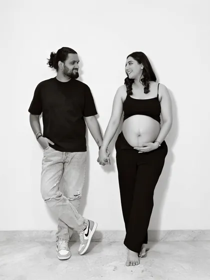 A fun and casual black and white portrait of a couple. Their genuine smiles and relaxed poses make this photo feel so authentic.