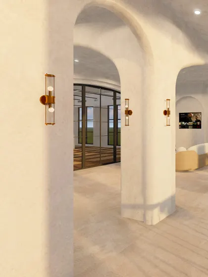 This shot captures the elegant arched passageways and classic wall sconces that connect different areas of the studio. The play of light and shadow on the textured walls creates a warm and sophisticated ambiance.
