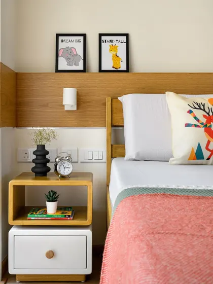 The custom bedside table in 'Amy and Joel's room' features a unique rotatable top shelf, adding a playful and functional element to the design.