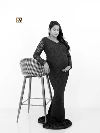 Another take on our black and white solo portrait. This image captures the quiet strength and beauty of the mom-to-be in a simple, elegant pose.