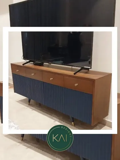 A stylized photo of our two-tone media console, highlighting its blend of wood and color. This piece is perfect for adding a touch of modern design to any living space.