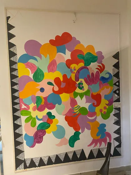 Here’s a look at the 'Freedom Mural' midway through. You can see how I layer shapes and colors, starting with big, bold forms and then filling them with intricate patterns. This layering process is what gives the final piece its depth.