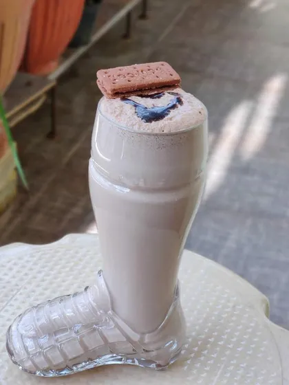 A thick and creamy Bourbon milkshake served in a fun boot-shaped glass, topped with a biscuit. A fun drink for kids and adults alike.