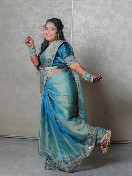 A playful and fun portrait of the bride kicking up her heel to show off her stylish shoes. It's a candid moment that reveals her personality and the joy of the celebration.