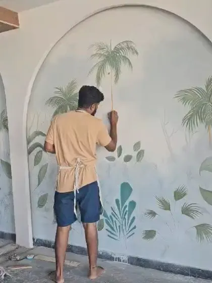 Another shot of the artist adding details to the wall mural.