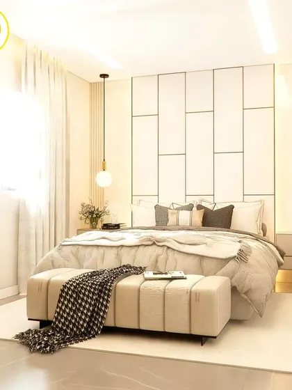 A wide view of the white bedroom, highlighting the natural light and the spacious feel.
