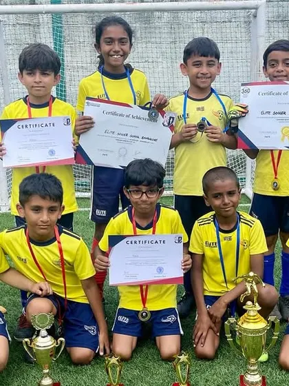 A proud team photo with their trophies and certificates. These moments of recognition are important for building confidence and motivating players.