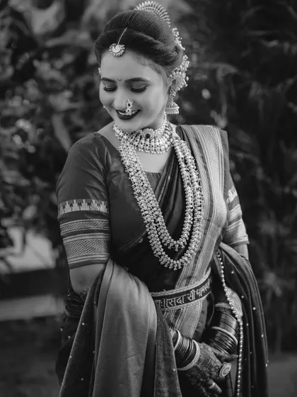 A timeless black and white portrait of a Maharashtrian bride. This style emphasizes emotion and the classic beauty of her attire, creating a photo that will never go out of style.