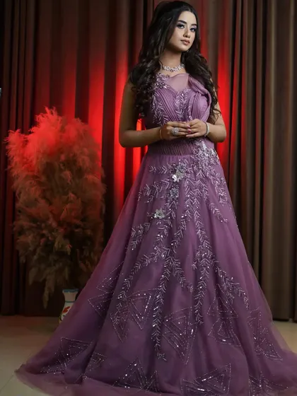 A full look at our new onion pink bridal gown. The intricate silver embroidery and flowing A-line skirt make this a stunning choice for a reception or engagement. This gown is available to rent, buy, or be customized.