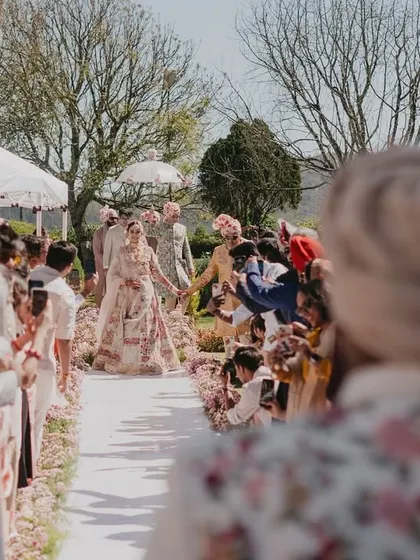 The bride's view as she walks down the aisle, with her groom waiting for her, a classic and emotional wedding moment.