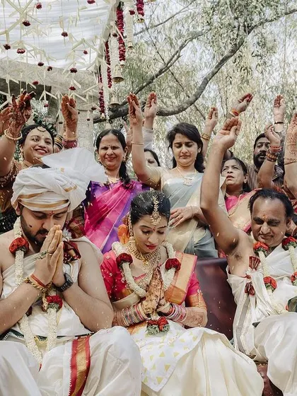 A beautiful moment of prayer and blessings with the entire family joining in. This wide shot captures the collective joy and spiritual significance of the wedding ceremony.