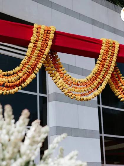 Simple yet beautiful decor details, like these thick garlands of yellow and orange marigolds, are essential for an authentic Mehendi or Haldi celebration.