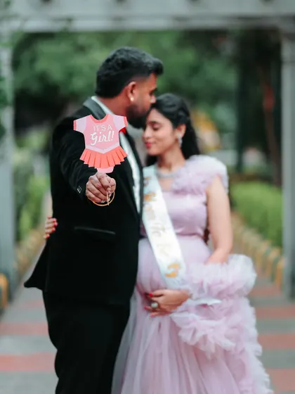 It's a girl! Using props like these adds a personal and fun touch to maternity photoshoots. The client is wearing a sash over her pink gown to share their happy news.