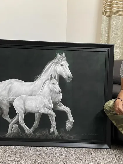 The finished 'Equine Companions' artwork, framed and resting in my studio. This gives a sense of the final product's scale and finish.
