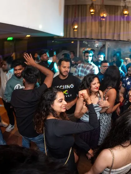 A wide angle shot of the dance floor at i-Bar, showing a mix of people dancing and socializing.