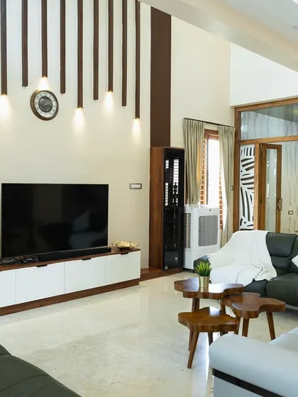 This living room features a striking TV accent wall with vertical wooden slats and integrated lighting. The design adds texture and visual interest, making the entertainment area a true centerpiece.