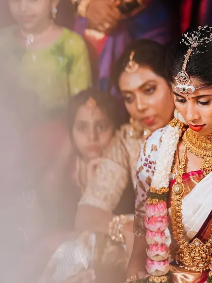 A quiet, contemplative moment for the bride during her wedding ceremony, surrounded by family.