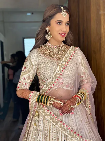 A beautiful portrait of the bride, showcasing her radiant smile and the flawless finish of her makeup.