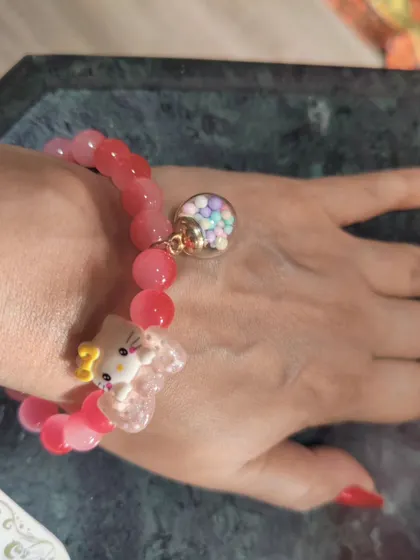 For the young at heart, this cute Hello Kitty charm bracelet is a fun and playful accessory. The pink beads and whimsical charms make it a sweet addition to a casual outfit.