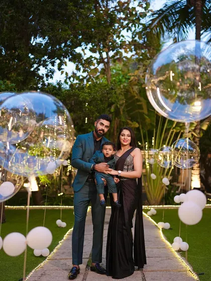 Another beautiful family portrait from the same event, capturing their coordinated style and the joy of the moment.
