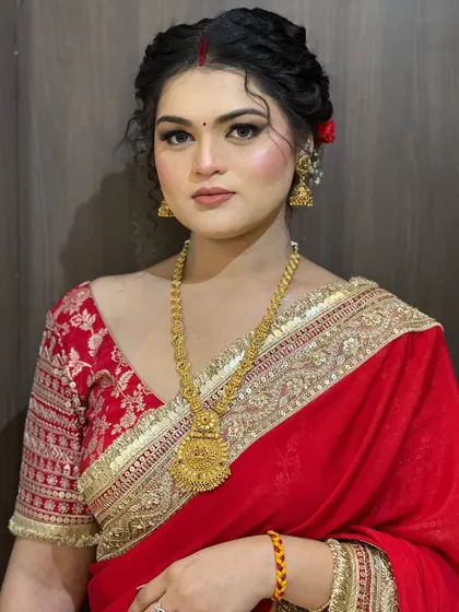 A full portrait of the client, looking poised and elegant in her traditional attire.