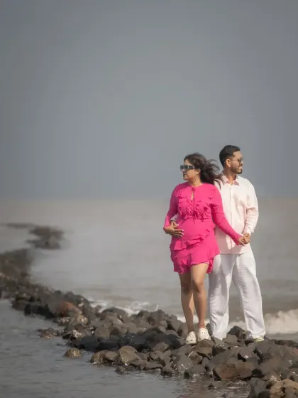 A beautiful maternity pre-wedding shoot on the rocks by the sea. This photo captures the couple's excitement and love as they await their new arrival.