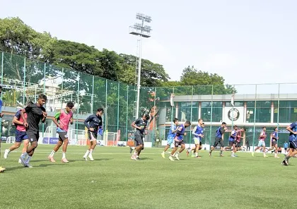 A dynamic shot of footballers sprinting during a training session. This image conveys the speed and power that our programs are designed to develop, preparing athletes for the highest levels of competition.