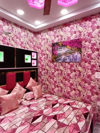 This bedroom is covered in a dense floral rose pattern, creating a vibrant and romantic atmosphere. The pink theme is continued in the bedding and headboard for a complete look.