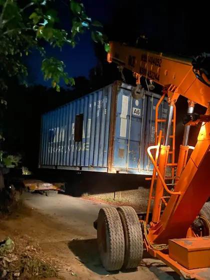Another container being maneuvered by a crane at night. My container projects often involve complex logistics to assemble the basic building blocks.