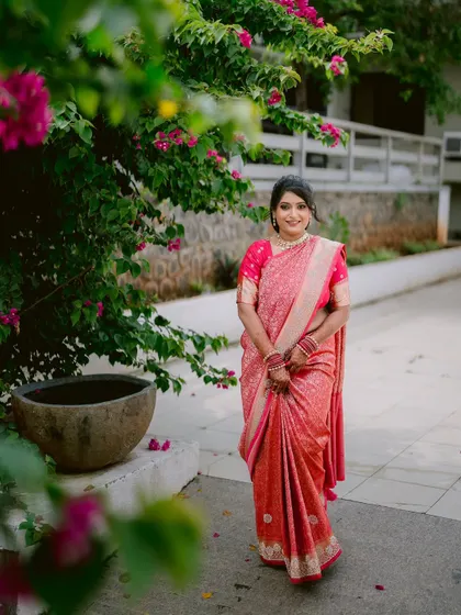 A lovely full-length portrait of the bride, Apeksha, in her beautiful pink saree.