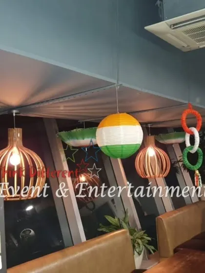 An office pantry area decorated with hanging tricolor rings and spheres. This shows how we can adapt our designs to fit different spaces, ensuring every corner of the office feels festive.