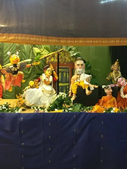 A puppet stage set for a performance, depicting a scene from a classic story. The stage, backdrop, and lighting are all carefully designed to create an immersive world for the audience.