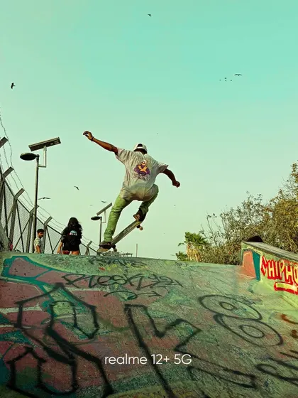 A low angle shot of a skateboarder on a ramp. This perspective makes the action feel more impressive and captures the energy of the moment.