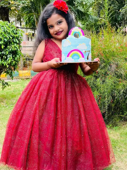 Here is the birthday girl with her rainbow cake. Seeing the joy on a child's face is the best part of being a baker.