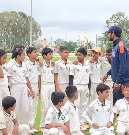 A coach addresses the U-12 team, providing instructions and encouragement.