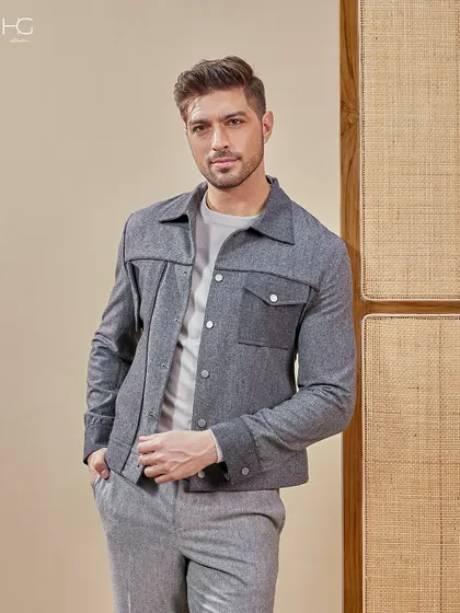 A closer look at the grey monochrome shacket, showing the texture of the fabric and the sharp tailoring that defines its effortless style.