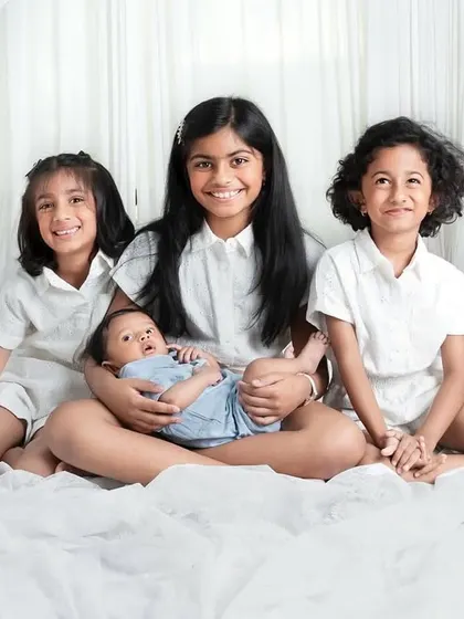 A beautiful portrait of cousins together, with the oldest girls holding the newest baby. A memory they will all cherish as they grow up.