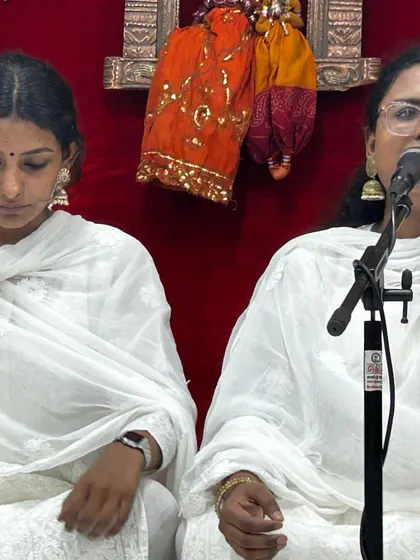 A close-up of the Nair sisters during their performance, showcasing their focus and synchronization.