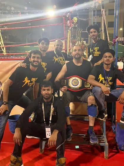 The team with the IAKO Pro Champion Title Belt. This is a testament to the high level of skill and dedication within our squad.