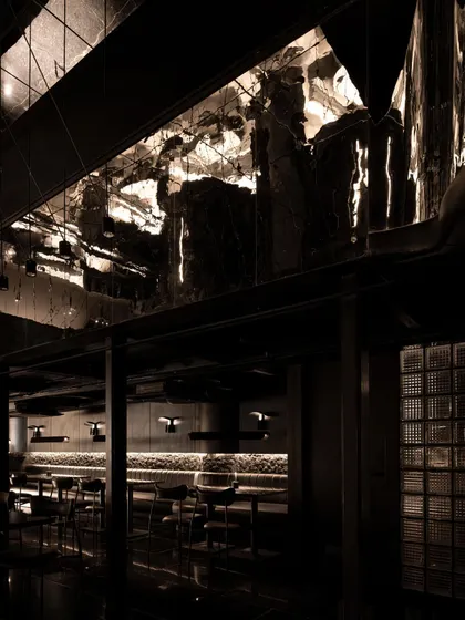A collection of atmospheric shots from Lair, showcasing the interplay of black concrete, glass blocks, polished steel, and dramatic lighting. Each image captures a fragment of the bar's mysterious and immersive character.