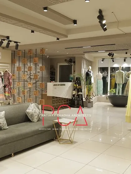 A view of the Jubinav Chadha studio from a different angle, showing a long sofa for waiting clients and the extensive clothing displays.