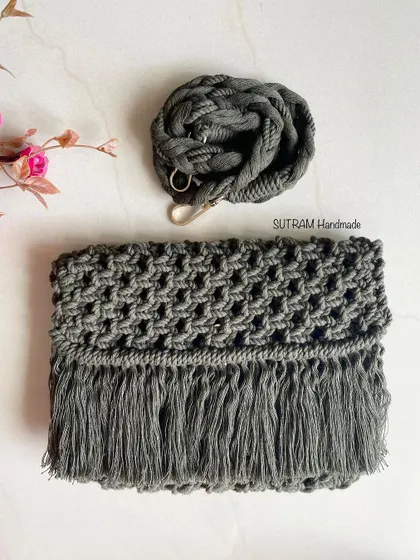 Another view of the olive green sling bag, showing the intricate knotting and the soft fringe. It's a perfect accessory for a relaxed, bohemian look.