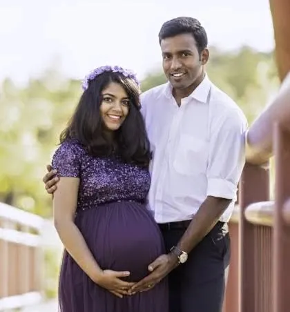 A smiling couple enjoying their outdoor maternity photoshoot. We capture the joy and partnership of expecting a child together.