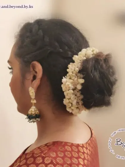 A side view of the messy bun with crown braids, showing how the braid frames the face and transitions into the bun. The gajra adds a traditional touch to this modern textured hairstyle.