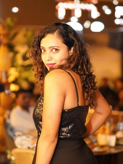 A guest looking back at the camera, her sequined top catching the light.