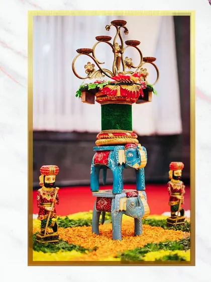 A unique and intricate centerpiece featuring painted wooden elephants and traditional figurines. These small, artistic details add personality and a cultural touch to the decor.