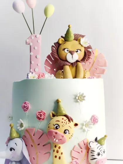 A close-up of the adorable, hand-molded animals from one of my most popular first birthday cake designs.