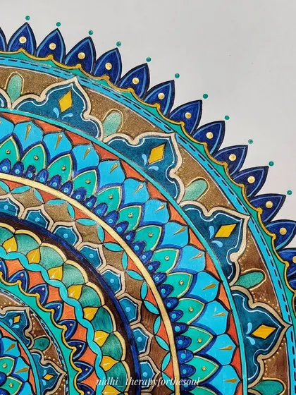 A close-up detail of the 'Peacock in the Desert Rain' mandala. This view highlights the intricate patterns and the clean lines that define the different colored sections.